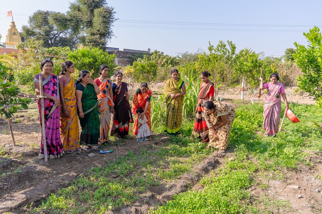 Group of women in colorful sarees working in a farm in Nagpur, India, highlighting rural agriculture life.